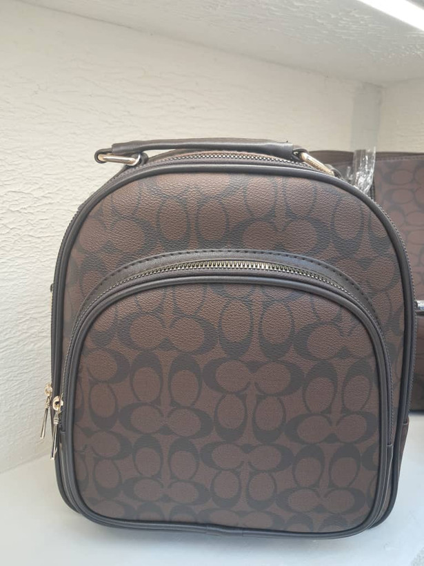 کوله پشتی زنانه طرح کوچ (Coach) مدل مینی مونوگرام رنگ قهوهای تیره